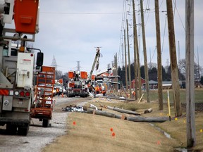 Hydro One crews were kept busy all day Thursday replacing hydro poles on Base Line Road, just outside of Wallaceburg, that were toppled by high winds on Wednesday night. (Ellwood Shreve/The Chatham Daily News)