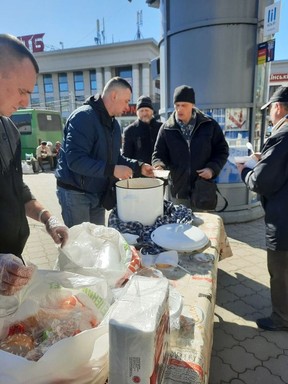 Team members are shown providing meals at the train station in Dnipro, Ukraine.  (Handout)