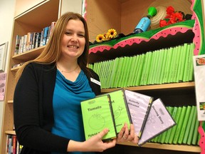 Cassey Beauvais, manager of public services with the Chatham-Kent Public Library, holds up a few of the types of seeds available to take out in this 2019 file photo.