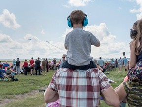 Adults and children watch aircraft perform at the Cold Lake Air Show on Sunday, July 22, 2018 after the weather cleared. An estimated 20,000 people  attended the two-day show. Credit: Cpl. Manuela Berger, 4 Wing Cold Lake