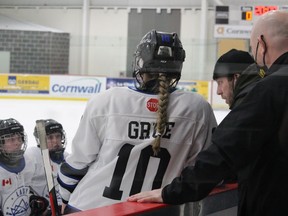 Cornwall Lady Royals head coach Troy Brownell (wearing a toque) speaking to the players between periods in Saturday's game against the Ottawa Senators U18 team.  Pictured on Saturday, March 5, 2022 in Cornwall, Ont. Todd Hambleton/Standard-Freeholder/Postmedia Network