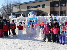 Teacher Amelie Gour with children on the left side of the ice fort entrance, and École élémentaire catholique Marie-Tanguay principal Julie Sauve with kids on the right side. Photo on Thursday, March 10, 2022, in Cornwall Ontario.Todd Hambleton/Standard-Freeholder/Postmedia Network
