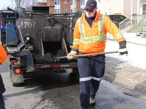 Denis Belanger with asphalt out of the hot box, to be applied on Cumberland Street. Photo on Monday, March 14, 2022, in Cornwall Ontario.Todd Hambleton/Standard-Freeholder/Postmedia Network