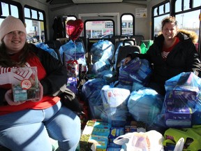 Stephanie Lapointe (left), campaign and communication co-ordinator with the United Way/Centraide of SDG, and executive director Juliette Labossière, in a city bus full of donations on what was Tampon Tuesday, the wrap-up to the annual campaign.Photo on Tuesday, March 23, 2022, in Cornwall Ontario.Todd Hambleton/Standard-Freeholder/Postmedia Network