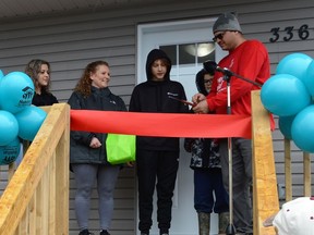 Some of the Leaf-Saucier family was present and smiling in anticipation during the ribbon-cutting ceremony to their new home on Thursday March 31, 2022 in Cornwall, Ont. Shawna O'Neill/Cornwall Standard-Freeholder/Postmedia Network