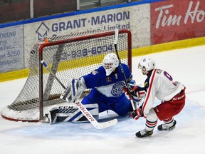 Cornwall Colts Wil McKinley, burying the puck over Navan Grads goaltender Carter Garvie's right shoulder in overtime, to give the Colts the win on Thursday March 10, 2022 in Cornwall, Ont. Robert Lefebvre/Special to the Cornwall Standard-Freeholder/Postmedia Network