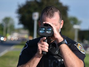 Handout/Cornwall Standard-Freeholder/Postmedia Network
A Cornwall Police Service officer with a speed-measurement device, from the service's 2021 annual traffic report.