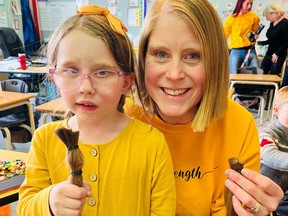 Ella and Mrs. Powers with some of the teacher’s newly-lost locks. Rocky View Schools