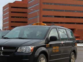 A cab operated by Sun Taxi is parked outside the Jubilee Centre and provincial building in Fort McMurray Alta. on Saturday January 30, 2016. Vince Mcdermott/Fort McMurray Today/Postmedia Network ORG XMIT: POS1607121933458998