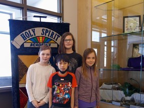 Students of Holy Spirit Academy pose for a picture at their school in High River on Thursday, March 24, 2022.