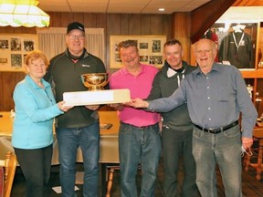 Chatham Granite Club president Martin Forster-Sands, centre, presents the Kent Cup of Curling to Granite Club skips Nora Snelgrove, far left, John Young Jr., Tim Welbanks and Reg Johnson after their championship win at the Chatham Granite Club in Chatham, Ont., on Saturday, March 19, 2022. (Contributed Photo)