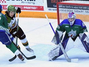 Liam Arnsby of the visiting North Bay Battalion battles with Nolan Collins of the Sudbury Wolves in front of goaltender Mitchell Weeks's net in Ontario Hockey League action Friday night. Arnsby returned to action after missing 20 games with an injury. Special to the North Bay Nugget
