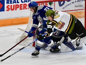 Kyle McDonald of the North Bay Battalion battles for the puck with Alex Pharand of the host Sudbury Wolves in their Ontario Hockey League game Sunday. The Troops entertain the Mississauga Steelheads on Thursday night.  Sean Ryan