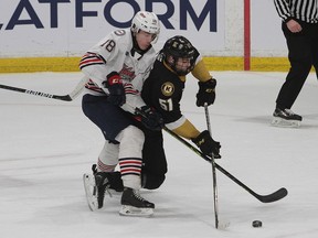 Kingston Frontenacs forward Shane Wright falls with Oshawa Generals Cooper Way as he is about to score Kingston's second goal of the game late in the first period in Ontario Hockey League action at the Leon's Centre on Friday night.