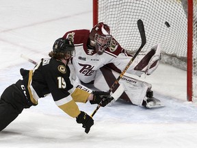 Kingston Frontenacs forward Paul Ludwinski scores on Peterborough Petes goaltender Michael Simpson while falling in Ontario Hockey League action at the Leon's Centre on Sunday.