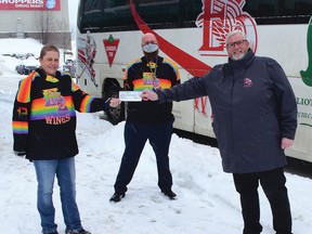 Photo by KEVIN McSHEFFREY/THE STANDARD
Elliot Lake Pride president Chantal MacEachern presents a $2,200 cheque to Mark Savery - Red Wings vice-president of operations/general manager, to cover the cost of the Pride jerseys. The funding for the jerseys came from a $2,500 donation from Elliot Lake’s TD branch manager Adam MacDonald (centre).