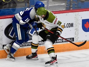 Alexander Lukin of the North Bay Battalion separates Nick DeGrazia of the host Sudbury Wolves from the puck in Ontario Hockey League action Sunday. The Battalion won 7-2 before a visit Thursday night by the Mississauga Steelheads. Sean Ryan