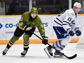Michael Podolioukh of the North Bay Battalion competes with Jake Uberti of the visiting Mississauga Steelheads in Ontario Hockey League play Thursday night. The top two teams in the Central Division fought for first place. Sean Ryan