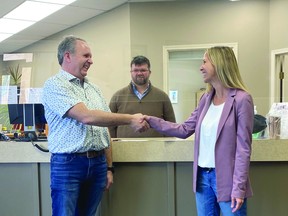 John G. Dozeman, left, was sworn in Friday, rejoining Nanton's council after winning the Feb. 28 byelection. Here, Dozeman shakes hands with Mayor Jennifer Handley, while Neil Smith, the Town's chief admiinistrator officer, looks on.