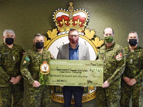 Garrison Petawawa raised $60,563 in support of the Government of Canada Workplace Charitable Campaign and a major recipient of the donations gathered by Petawawa's Defence Team is the United Way East Ontario. Taking part the cheque presentation at Garrison Petawawa on March 7 were (from left) Chief Warrant Officer Jack Durnford and Col. John Vass, 4 Canadian Division Support Group; Jamie Bramburger representing  United Way East Ontario; Col. Eric Landry and Chief Warrant Officer Jeramie Leamon of 2 Canadian Mechanized Brigade Group.