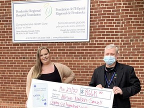Allison Neilson-Sewell accepts her cheque for $8,668 as the winner of the week 35 prize in the Pembroke Regional Hospital Foundation Catch the Ace progressive lottery. Presenting the cheque was PRHF executive director Roger Martin (right).