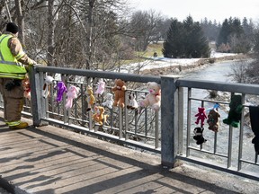 Mike Montgomery of the WPFD keeps watch from the Wellington Street bridge in Mitchell while a couple dozen stuffed animals were affixed to the bridge as the search for a missing 10-year-old child continues March 9 - the fourth day of their search. The OPP and other trained personnel are continuing the search and with Whirl Creek receded a noticeable amount all hope for some closure in this tragic circumstance. ANDY BADER/MITCHELL ADVOCATE