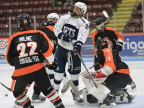 Griffin Sinden screens Burford goalie Devon Popp during the PJHL game Tuesday in Woodstock.