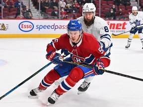 Michael Pezzetta of the Montreal Canadiens and Jake Muzzin of the Toronto Maple Leafs skate against each other during the second period at Centre Bell on Feb. 21, 2022 in Montreal.