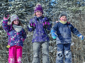 QUEENS AND KING OF THE HILL Catherine 6, Lily-Anna, 8, and Liam, 5, find playing on the high snowbanks at Hiawatha Highlands Saturday is just as fun as skiing and snowshoeing. The children were watching the Ontario Youth Cross Country Ski Championships with their parents when they moved off to have some fun of their own. BOB DAVIES