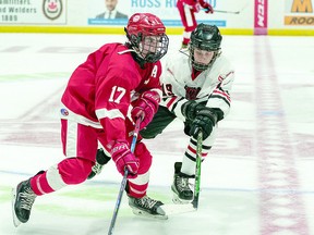 CARTER CARRIES ON Scoring leader Carter Huckson (17) of the under 15 Soo Jr. Greyhounds carries the puck past a Copper Cliff Reds checker in recent Nickel District Hockey League action. The U15 Jr. Greyhounds are headed to Kapuskasing this weekend for the Northern Ontario Hockey Association regional championships. BOB DAVIES