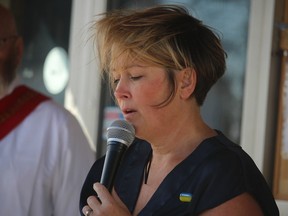 Leslie Skolly of Camlachie sings the Ukrainian national anthem Sunday during a vigil for Ukraine held Sunday in the parking lot of Branch 216 of the Royal Canadian Legion in Petrolia.