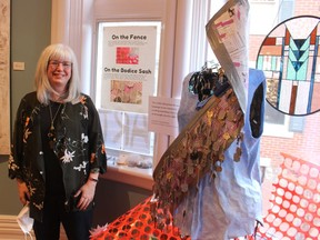 Artist Mary Abma stands next to The Fence Project, a community art piece she created in partnership with the Women's Interval Home. A wrap-up event for the project is being held Sunday, 3 p.m., at the Lawrence House Centre for the Arts.