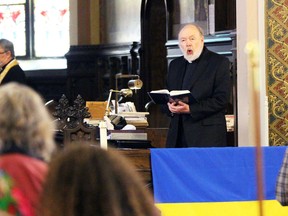 Rev.  Paul Woolley sings a hymn during a multi-faith community event at All Saints Anglican Church in support of Ukraine amid the Russian invasion on Sunday, March 20, 2022 in Sarnia, Ont.  Terry Bridge/Sarnia Observer/Postmedia Network