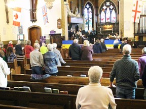 The congregation stands during a multi-faith community event at All Saints Anglican Church in support of Ukraine amid the Russian invasion on Sunday, March 20, 2022 in Sarnia, Ont.  Terry Bridge/Sarnia Observer/Postmedia Network