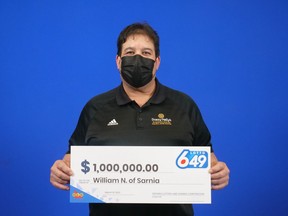 William Nahmabin of Sarnia is shown at the OLG prize centre in Toronto collecting a $1 million prize in the March 2 Lotto 6/49 draw.