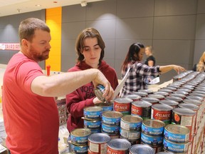 Shaun Tobin and Madeline Taylor help to build a structure for Exit Realty Saturday at Canstruction in Lambton Mall.