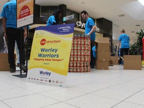 A team from Worley assembles an entry Saturday for Canstruction at Lambton Mall in Sarnia.  The event raises food and cash donations for the Inn of the Good Shepherd food bank.