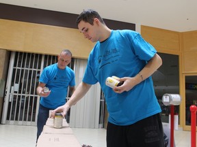 Dillon Brighton helps assemble an entry Saturday at Canstruction at Lambton Mall for the team from Diversity Ed.