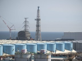 This picture taken on March 5, 2022 shows reactor buildings and storage tanks for contaminated water at the Tokyo Electric Power Company (TEPCO) Fukushima nuclear power plant.