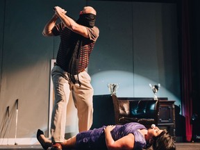 Bingham (Craig Matthews) tees up a golf ball in Pamela's (Rhonda Ross) mouth in a scene from "A Fox on the Fairway" running at Sarnia's Imperial Theatre through Sunday.