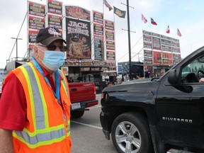 Jack Struck, with the Sarnia Kinsmen Ribfest, watches the line last year as at drive-thru event held in a parking lot at Lambton College.  This year's Ribfest is returning to Centennial Park June 17 to 19.