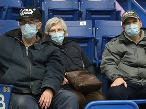 Fans wearing masks follow the action at the Sudbury Wolves game against the Soo Greyhounds at the Sudbury Community Arena in Sudbury, Ont. on Wednesday March 9, 2022. Ontario will drop most mask mandates on March 21. John Lappa/Sudbury Star/Postmedia Network