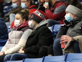 Fans wearing masks follow the action at the Sudbury Wolves game against the Soo Greyhounds at the Sudbury Community Arena in Sudbury, Ont. on Wednesday March 9, 2022. Ontario will drop most mask mandates on March 21. John Lappa/Sudbury Star/Postmedia Network