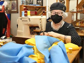 Barbara Smatlanek sews together material to make a Ukrainian flag at the Ukrainian Centre on Tuesday. The centre is selling flags, bracelets and food with the proceeds being donated to the Ukraine humanitarian effort. The centre will match food sales. For more information, call 705-673-7404.