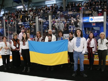 Choir members from the Ukrainian National Federation sing the Ukrainian national anthem prior to the start of the Sudbury Wolves game against the Kingston Frontenacs at the Sudbury Community Arena in Sudbury, Ont. on Friday March 4, 2022. The local Ukrainian community wanted to show their support for Ukraine with the hope of peace. John Lappa/Sudbury Star/Postmedia Network