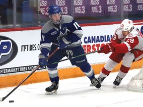 Landon McCallum, left, of the Sudbury Wolves, attempts to evade Kirill Kudryavtsev, of the Soo Greyhounds, during OHL action at the Sudbury Community Arena in Sudbury, Ont. on Wednesday March 9, 2022. John Lappa/Sudbury Star/Postmedia Network