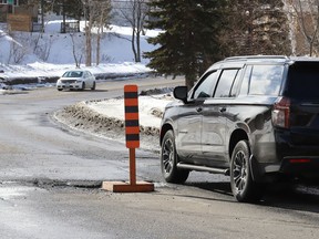 A hazard sign located on Bellevue Avenue in Sudbury, Ont., warns motorists of a large pothole on Friday March 11, 2022. John Lappa/Sudbury Star/Postmedia Network