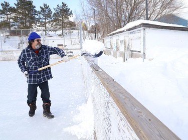 Vic Desormeaux shovels snow off the rink at Antwerp Playground in Sudbury, Ont. on Friday March 11, 2022. John Lappa/Sudbury Star/Postmedia Network