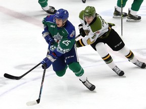 Dominik Jendek, left, of the Sudbury Wolves, and Michael Podolioukh, of the North Bay Battalion, race to the puck during OHL action at the Sudbury Community Arena in Sudbury, Ont. on Friday March 11, 2022. John Lappa/Sudbury Star/Postmedia Network