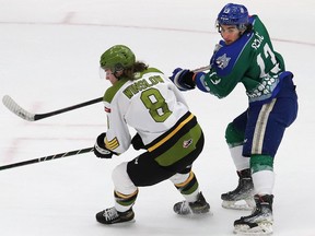 Kocha Delic, right, of the Sudbury Wolves, and Avery Winslow, of the North Bay Battalion, battle for position during OHL action at the Sudbury Community Arena in Sudbury, Ont. on Friday March 11, 2022. John Lappa/Sudbury Star/Postmedia Network